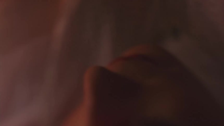 Partially visible face from low angle with warm lighting and soft focus