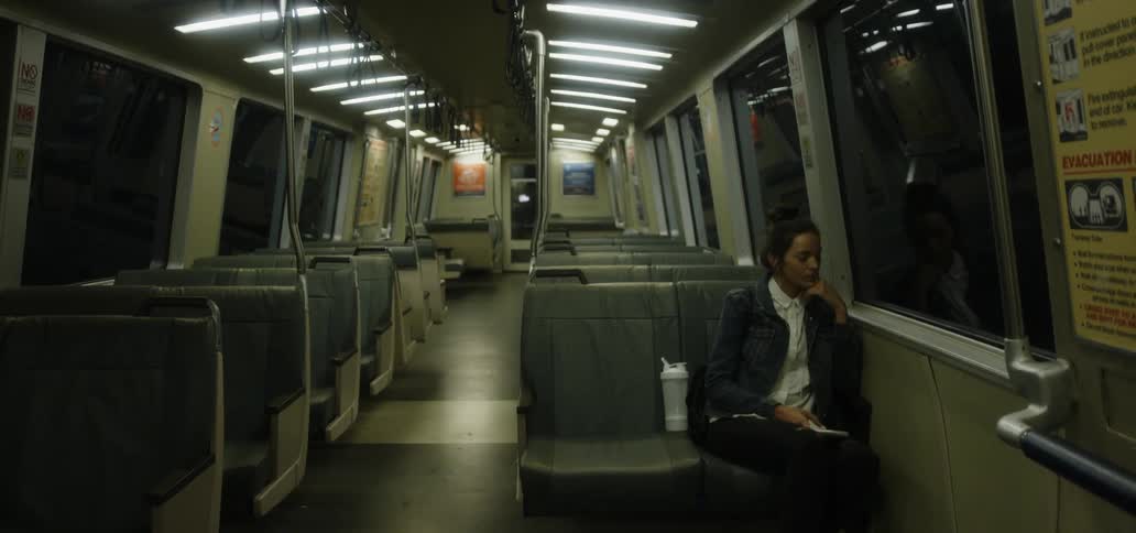 A woman rides a subway by herself
