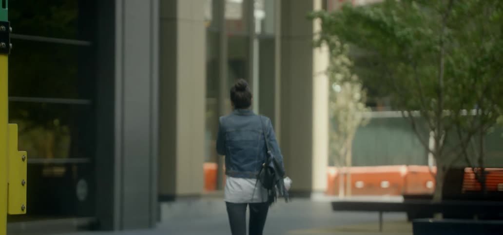 A woman walks down a city street