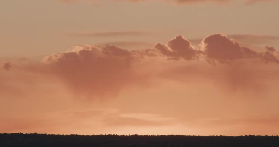 Sunlight reflects on clouds floating over the landscape