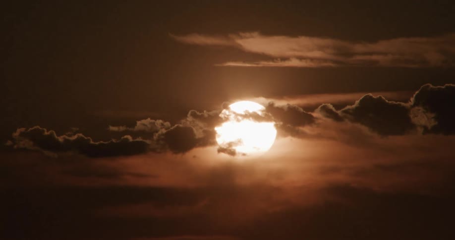 A view of the sun rising over some clouds