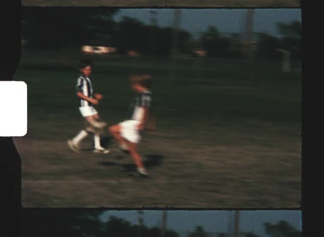 The children kick the soccer ball back and forth