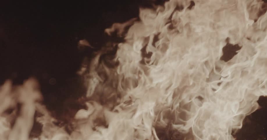 Intense flames against dark background with swirling fire patterns