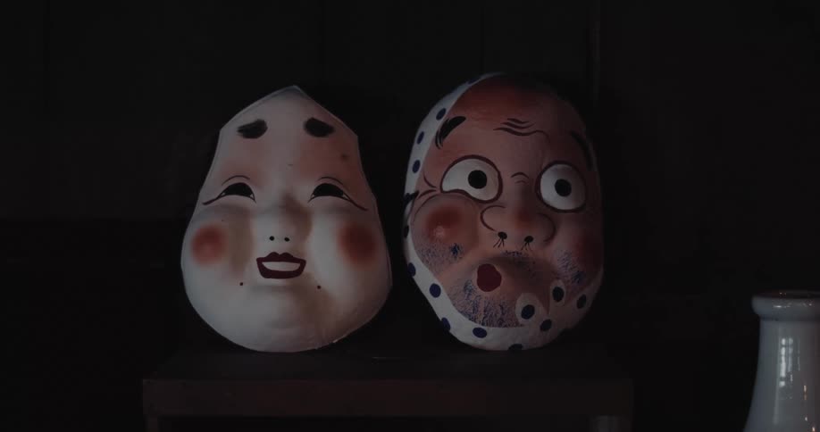 Traditional japanese masks on dark wooden surface