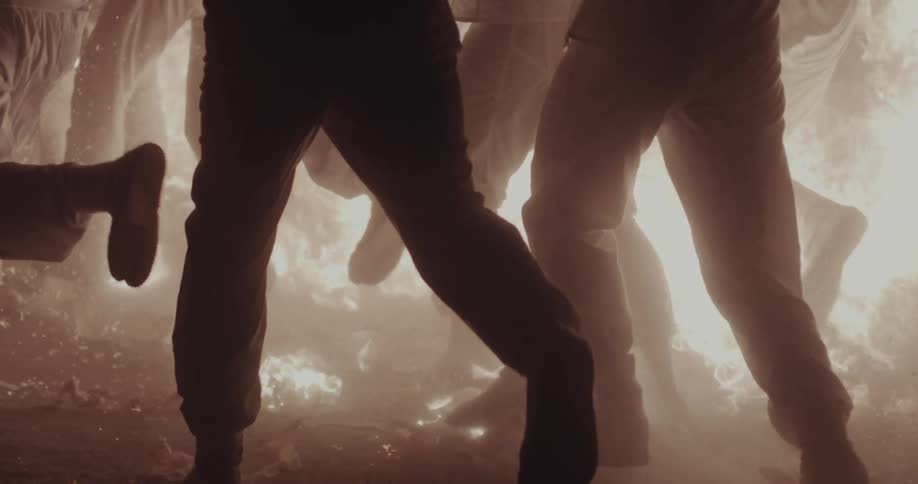 Group of people running through the fire at night