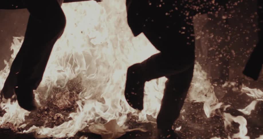 Group of people running through the fire at night