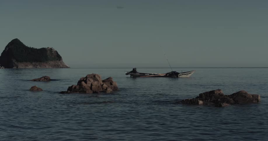 Small boat floating in calm waters