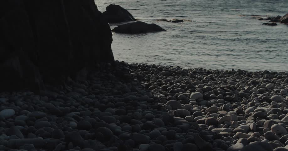 Rocks and stones on the coast as waves roll in to shore