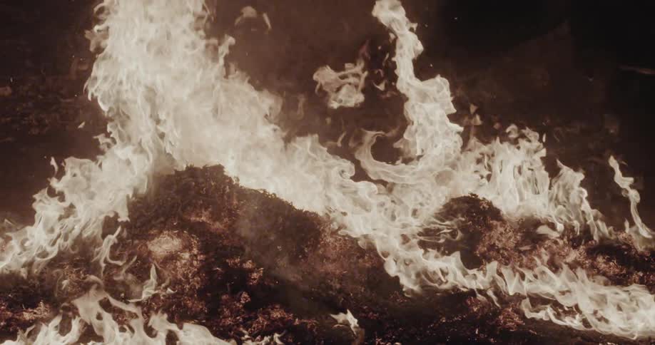 Intense fire consumes dry vegetation in dark area