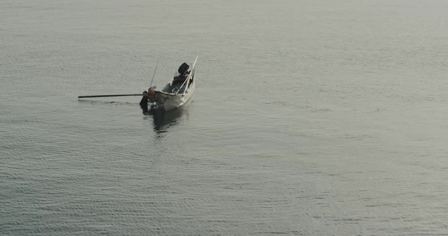 Canoe with equipment floating in calm waters