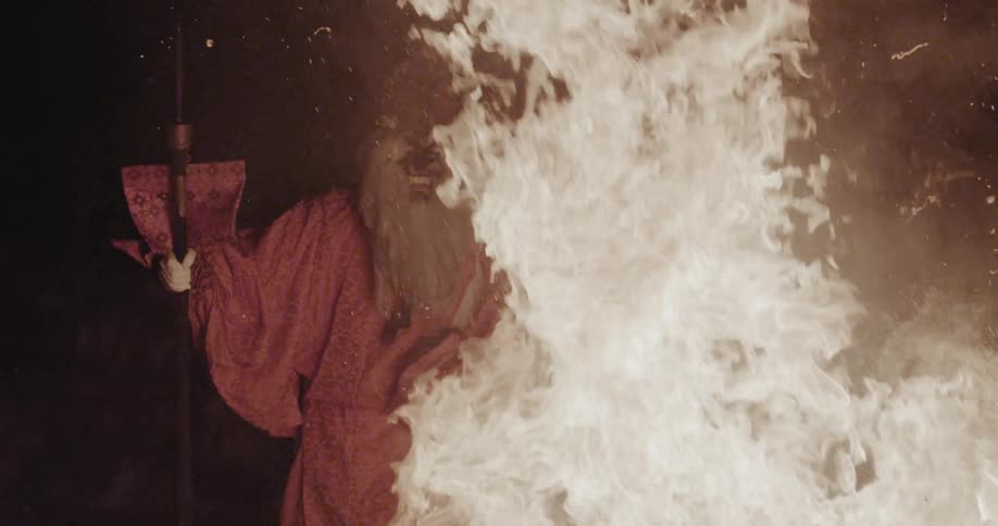 A person standing next to a fire