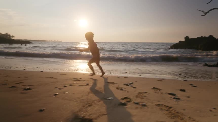 A child playing outdoors on the beach