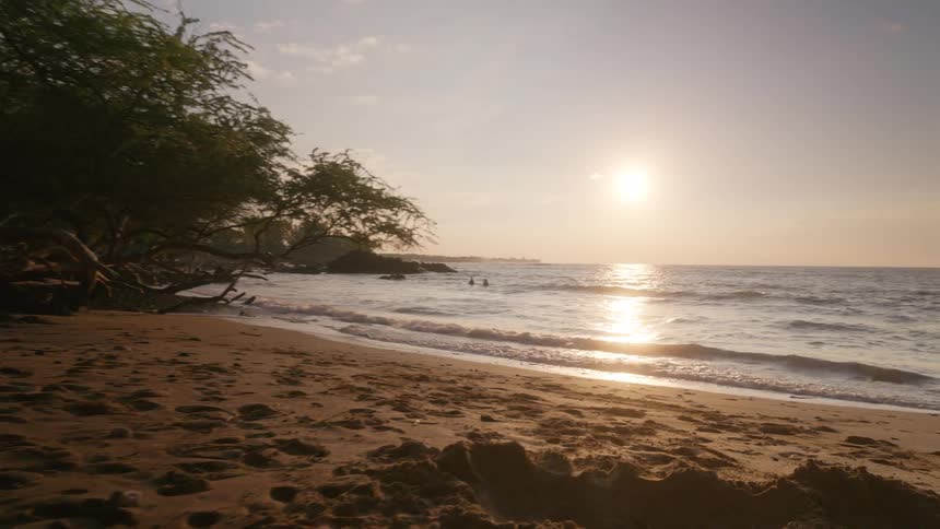 The girl runs towards the water as the sun rises