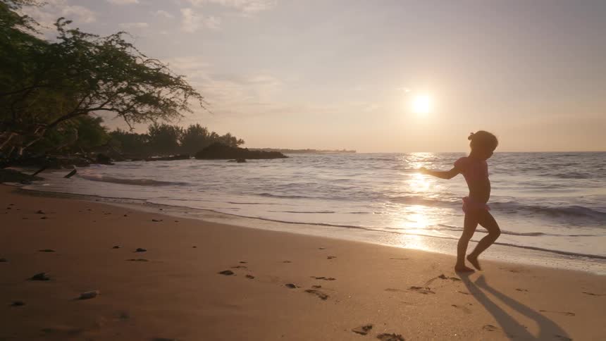 A little girl playing on a beach