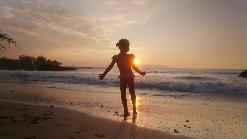 A child running outdoors on the beach