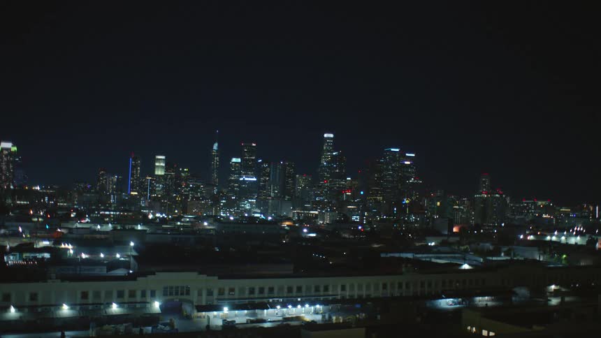 Downtown los angeles lit up as seen from industrial zone at night