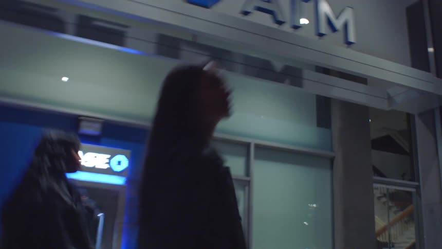 Women walking in a nighttime urban area with motion blur effect