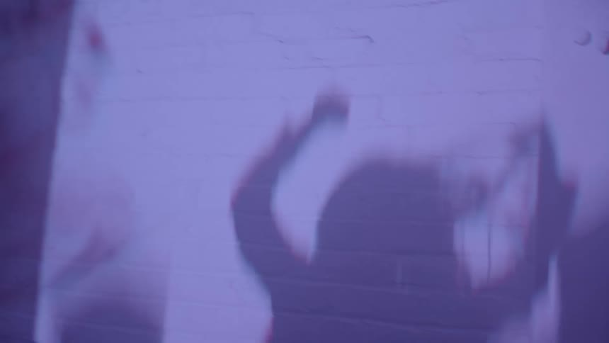 Silhouettes of people dancing in a club