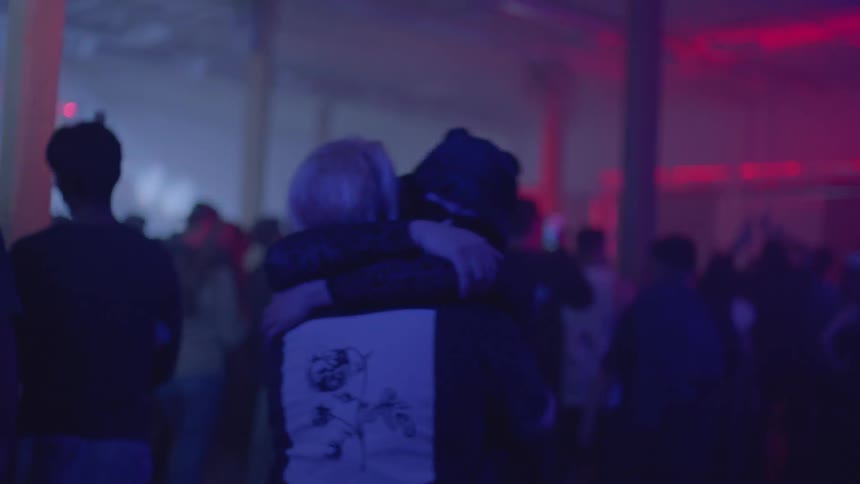 A group of people dancing at a club