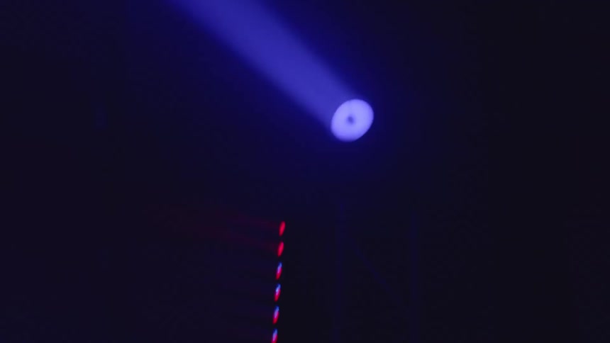 The strobe light moves in the dark club