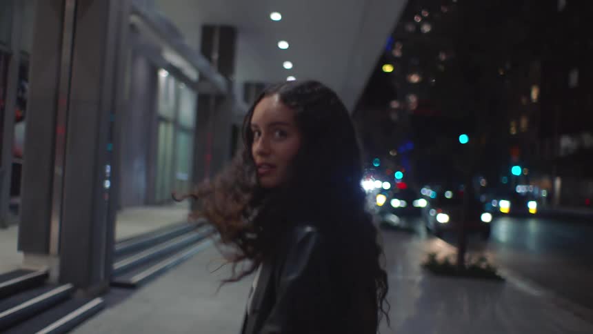 The women hold hands and run in the city