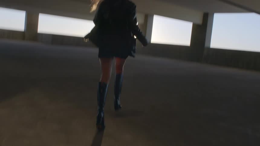 The woman is running in the parking garage