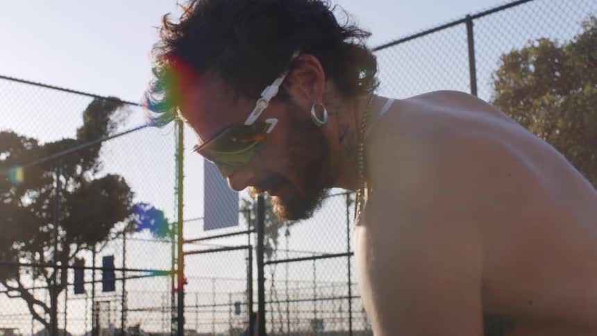 Man in sunglasses focused on an outdoor court