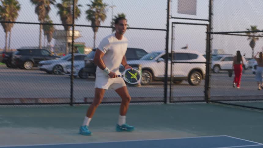 The man wearing all white is playing tennis
