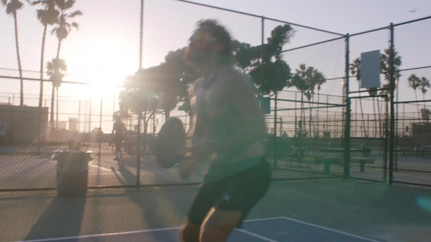 A man playing tennis outdoors