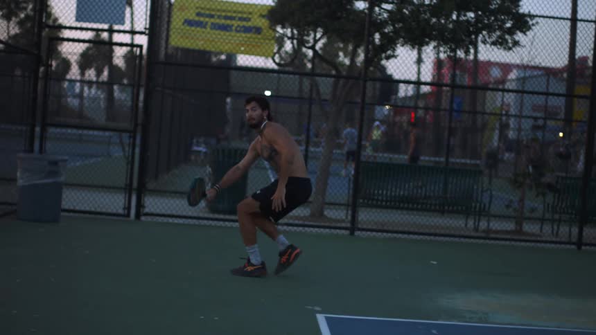 The man races to hit the tennis ball