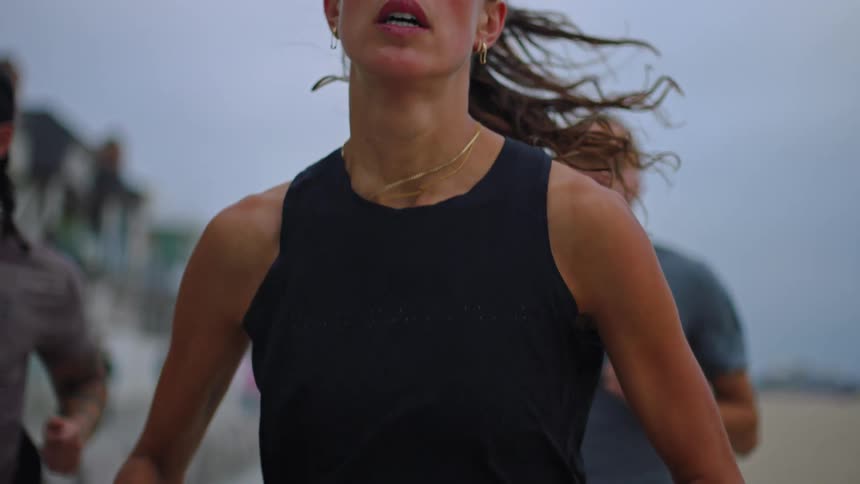 Woman running ahead of other runners in a race