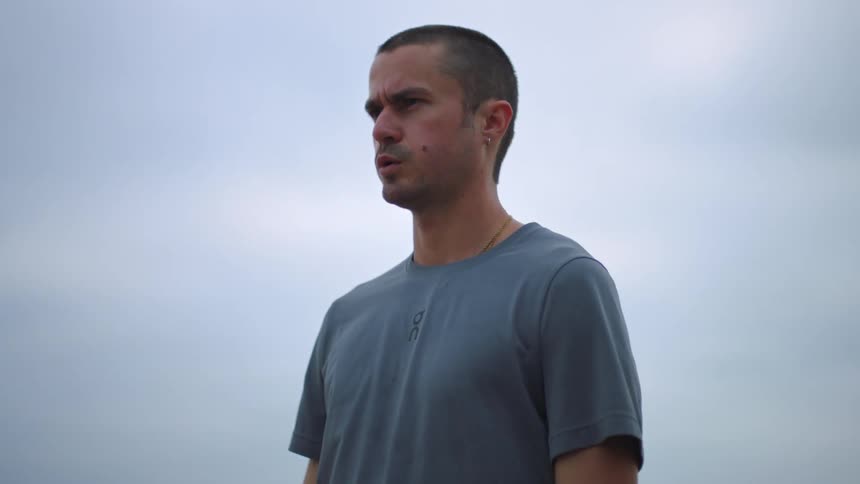 Man standing outdoors takes a deep breath