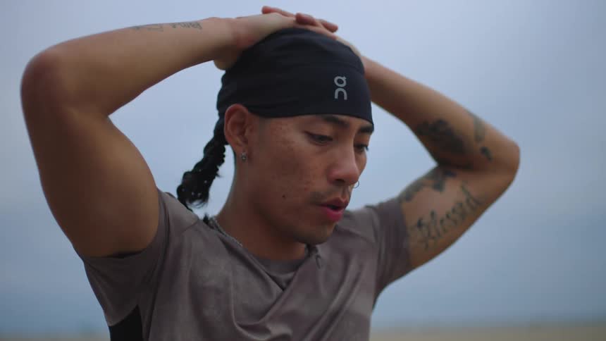Man with hands on his head breathing deeply