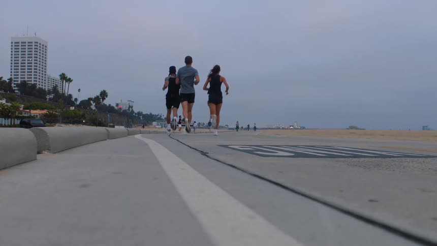 A group of people run together down a path