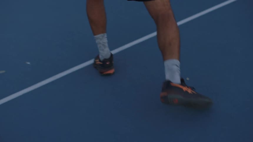 Mans legs moving on a sports court