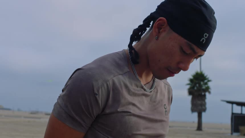 Man outdoors stretching his arms