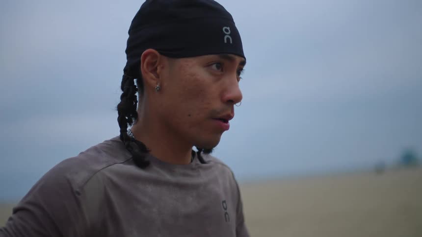 The face of a young man a man wearing a black beanie staring straight ahead