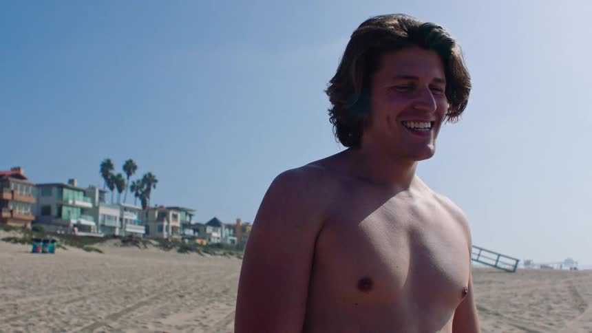 A man standing outdoors on the beach