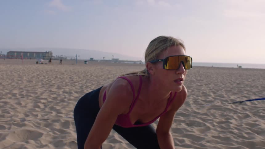 Woman positioning her hands during a sporting activity on the beach sand