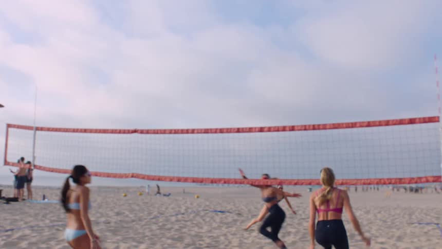 Pair celebrating after scoring a point in beach volleyball