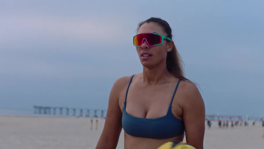 Woman handling a beach volleyball outdoors