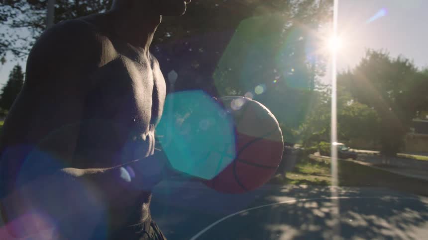 Two men on an outdoor court playing basketball