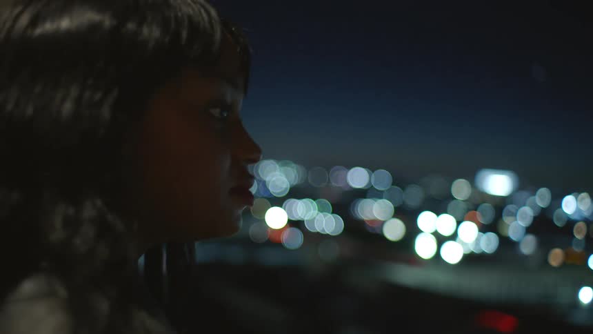 Woman observing the horizon at night