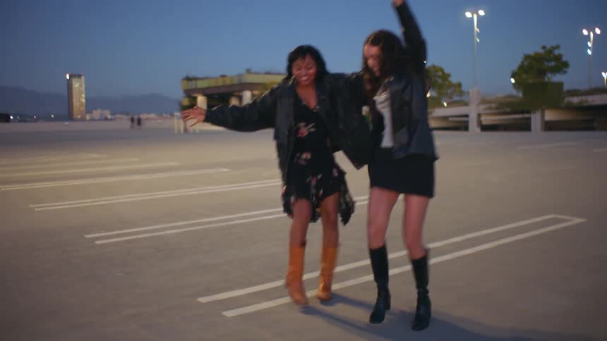 Two women dancing outdoors