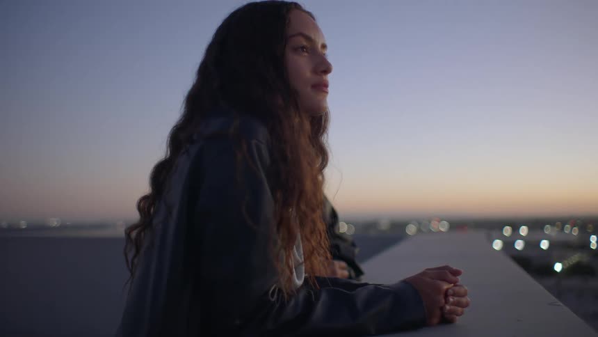 Two women enjoying the sunset view in an outdoor area