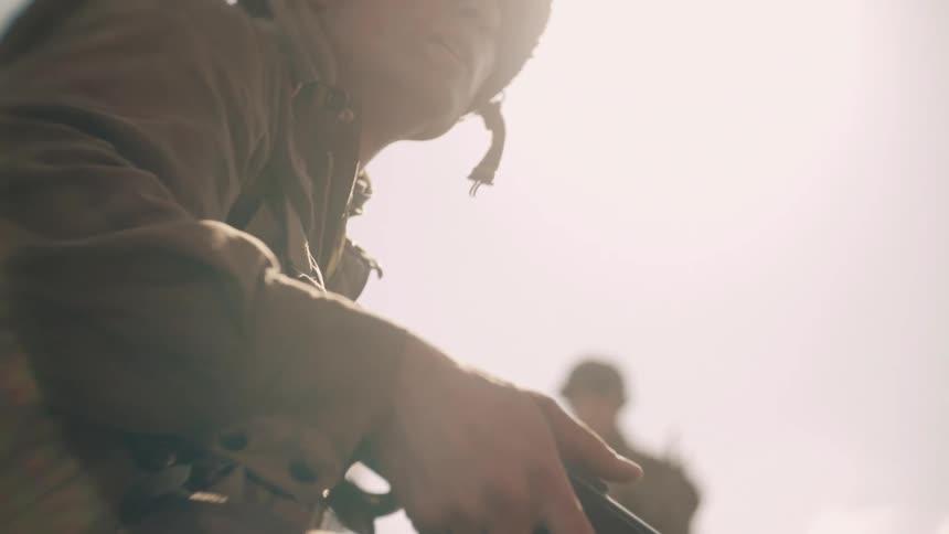 A soldier holding a gun outdoors