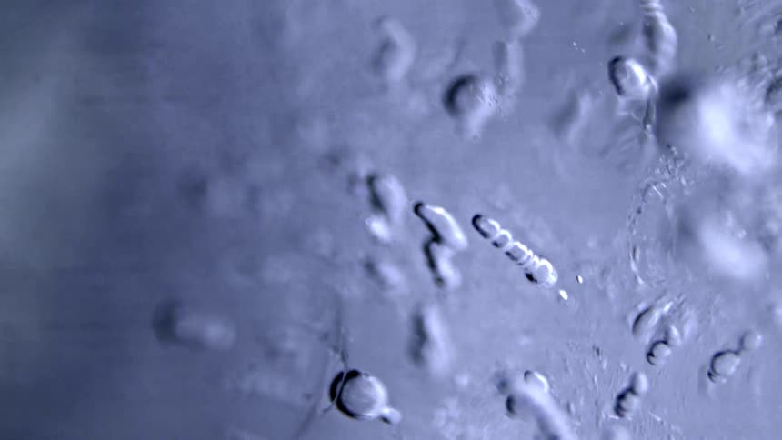 Liquid forming bubbles as they rise and escape to the surface