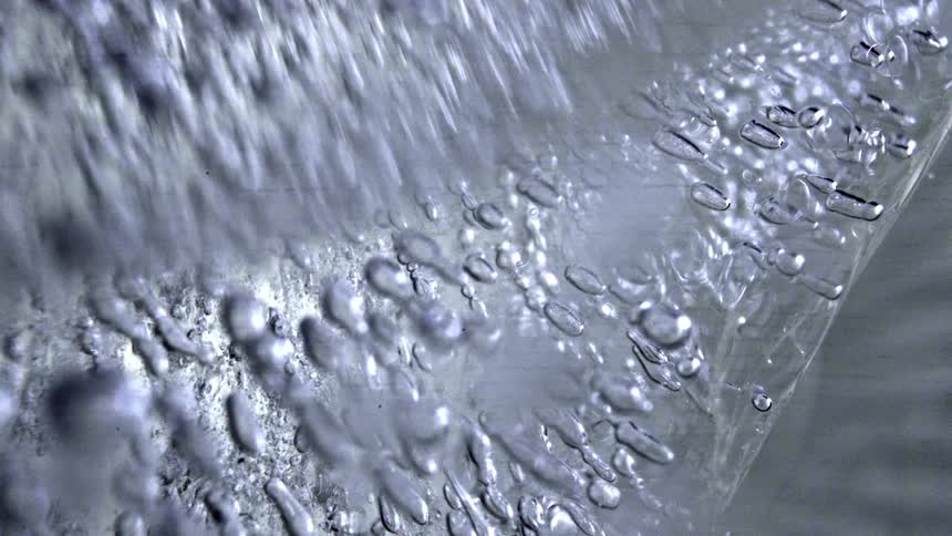 Translucent ice with elongated bubbles and striated textures seen in closeup