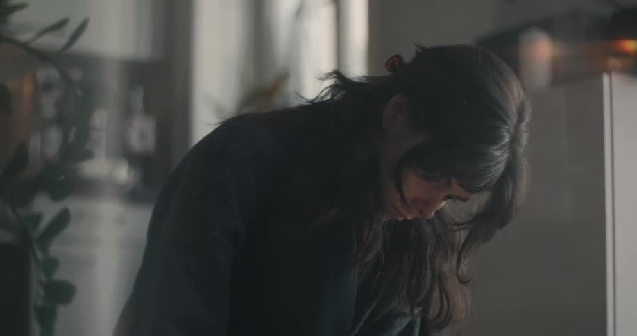 Woman focused downward while working indoors during the daytime