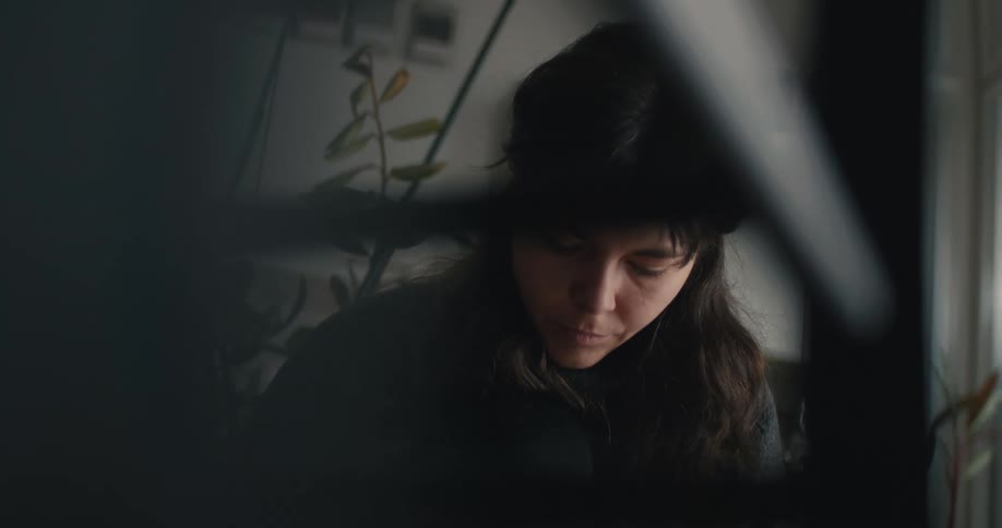 A portrait of a woman sitting in a room